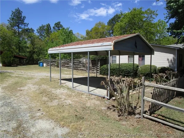 a view of a house with backyard and porch