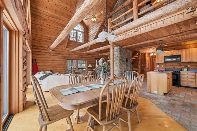 a dining room with furniture and a kitchen view