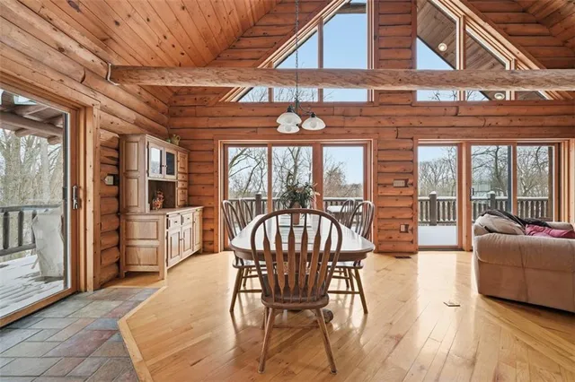 a view of a dining room with furniture large windows and wooden floor