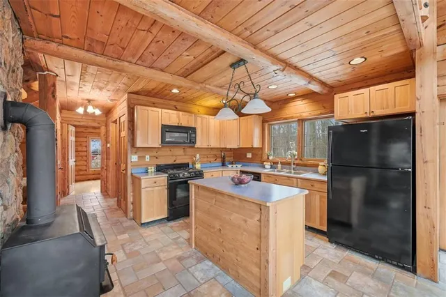 a kitchen with refrigerator and cabinets