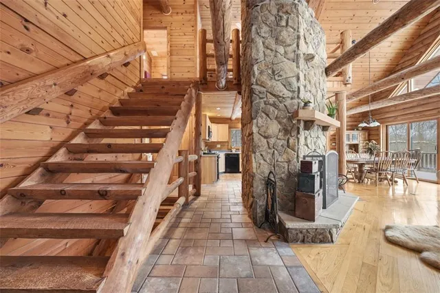 a view of a room with stairs wooden floor and windows