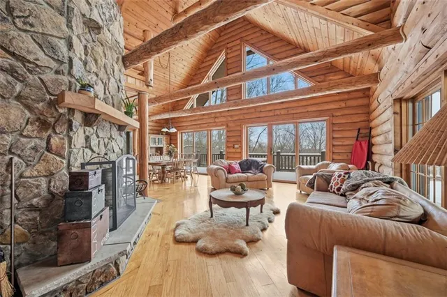 a view of a patio with couches and dining table and chairs with wooden floor