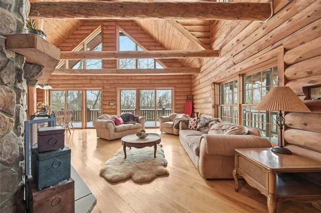 a living room with fireplace furniture and a large window
