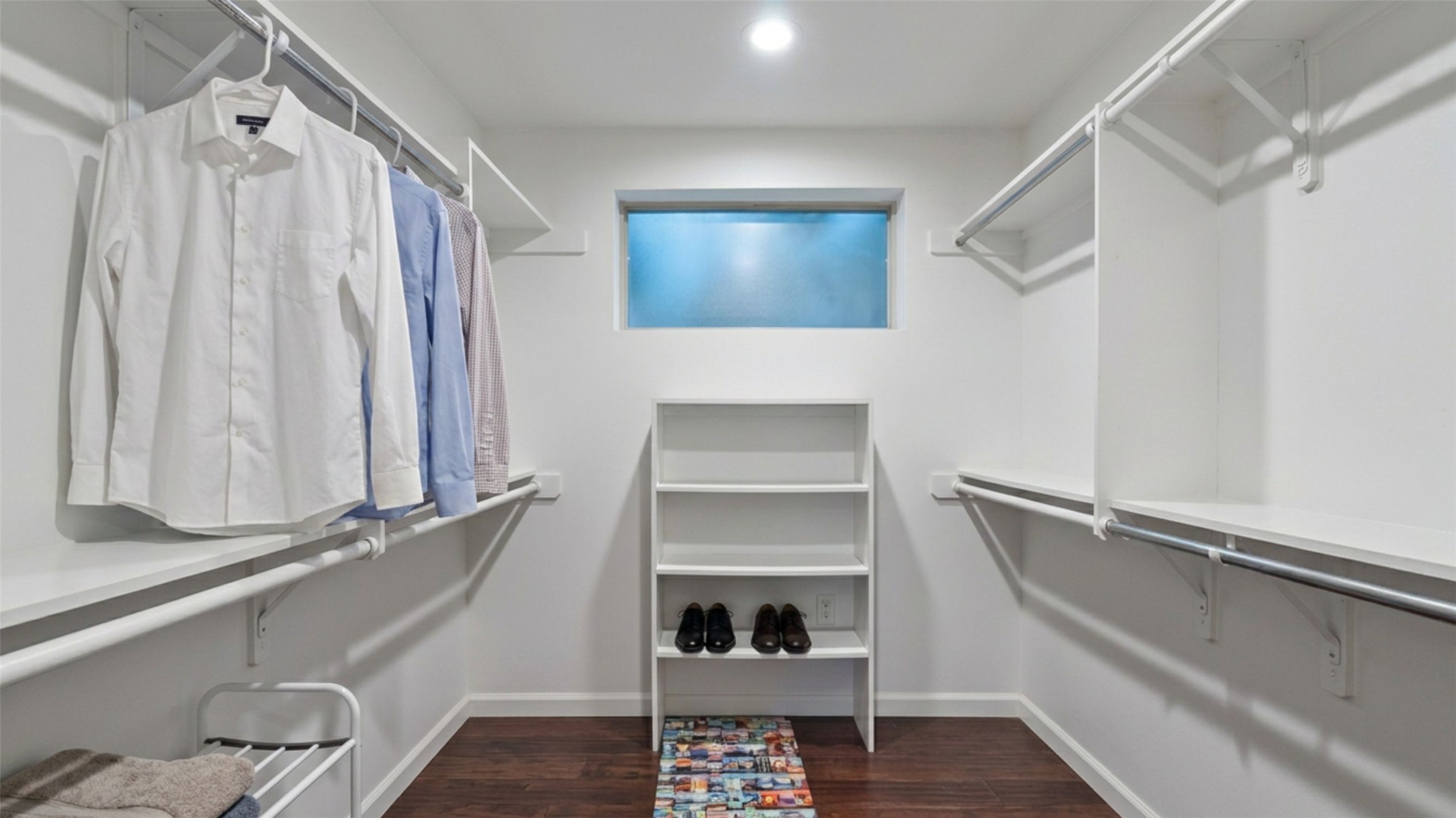 1158 Ridgeway Drive, Unit A Austin, TX 78702 - Photo 15 of 28 A well-organized walk-in closet offers ample storage with shelving and hanging space.