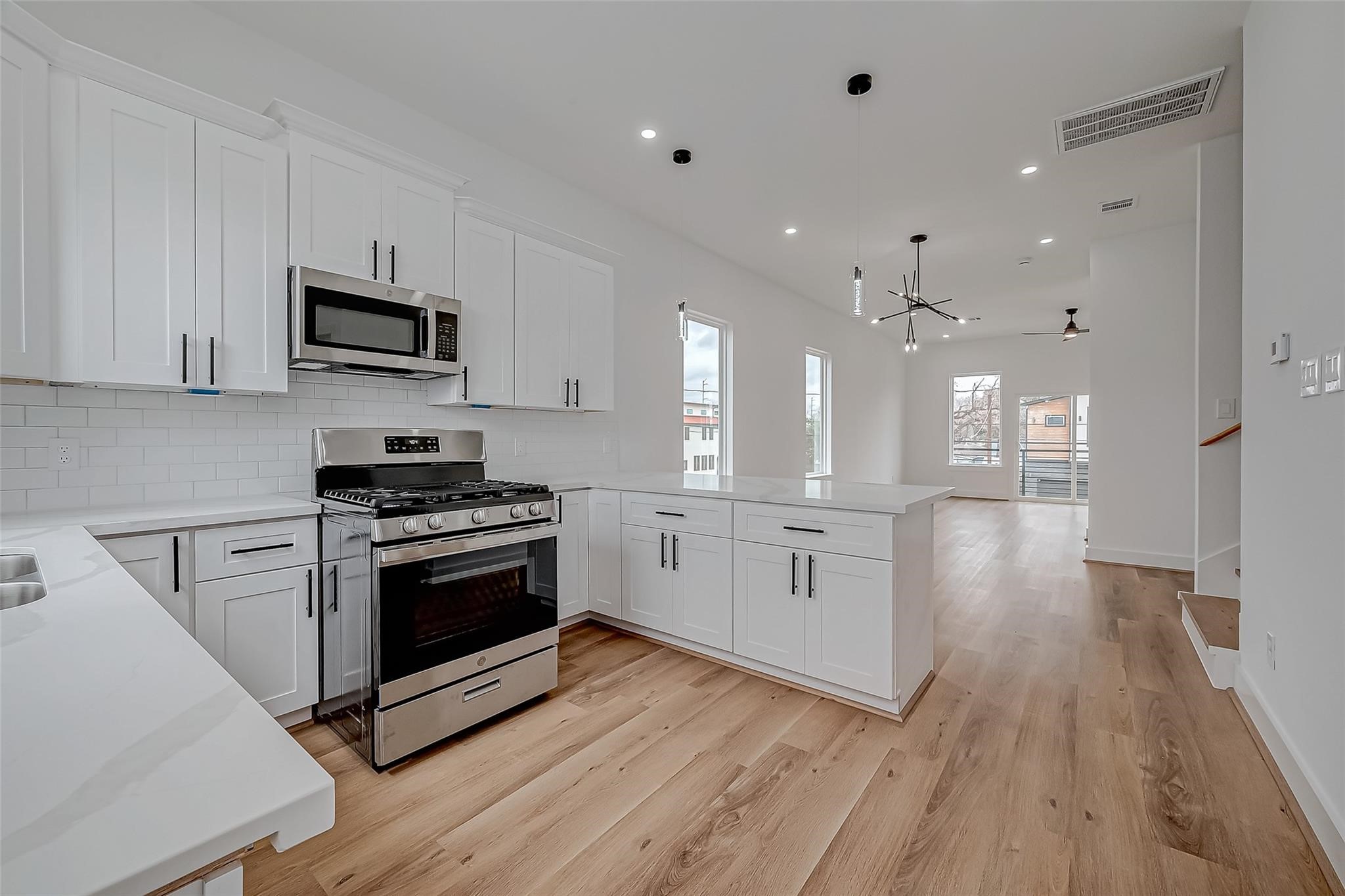 3624 Goodhope Street Houston, TX 77021 - Photo 15 of 32 a kitchen with stainless steel appliances kitchen island granite countertop a stove a sink and white cabinets