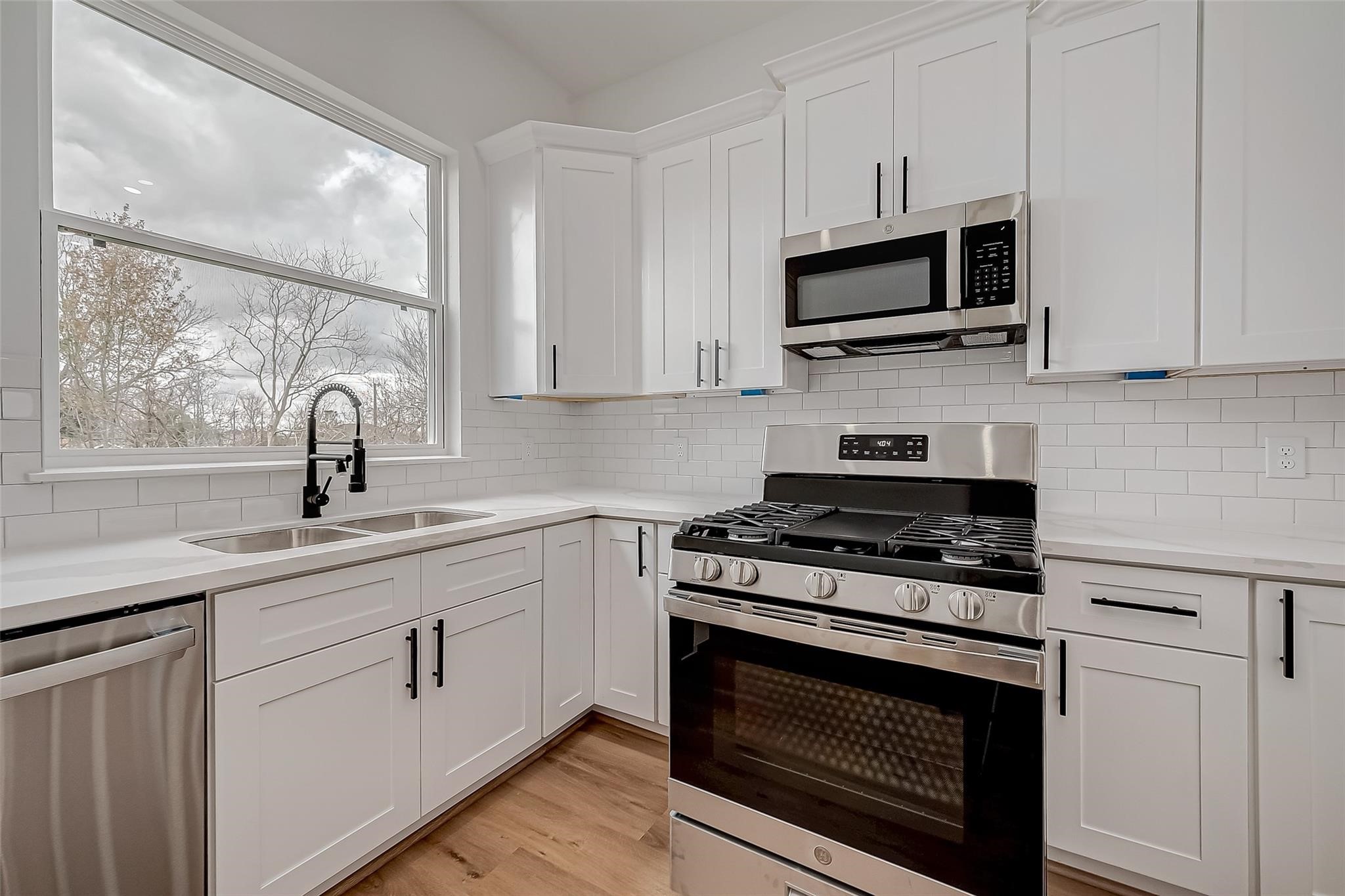 3624 Goodhope Street Houston, TX 77021 - Photo 16 of 32 a kitchen with white cabinets and appliances