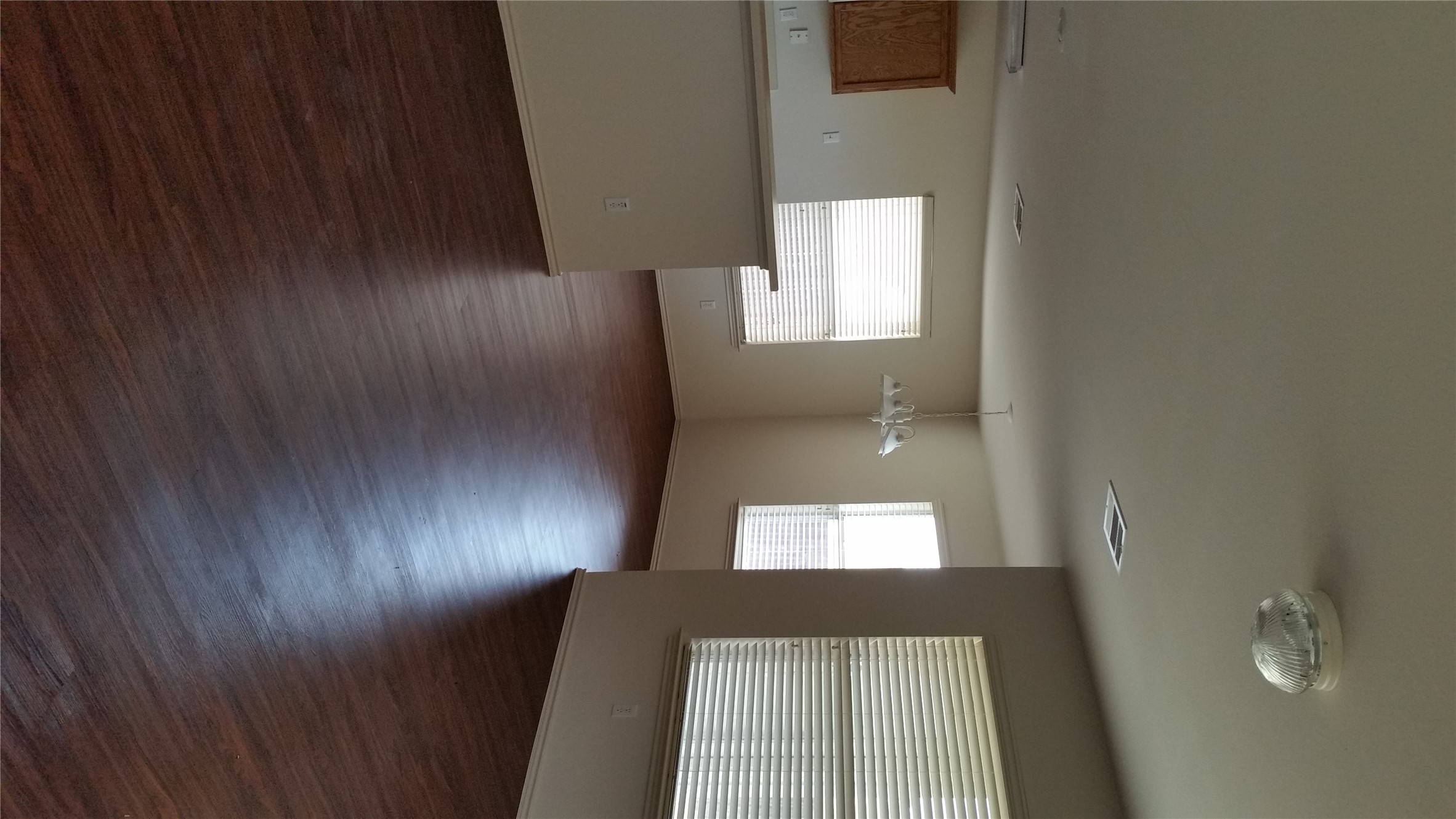 1324 Peppermint Trail Pflugerville, TX 78660 - Photo 7 of 33 Unfurnished room featuring dark wood-style floors, healthy amount of natural light, and a chandelier