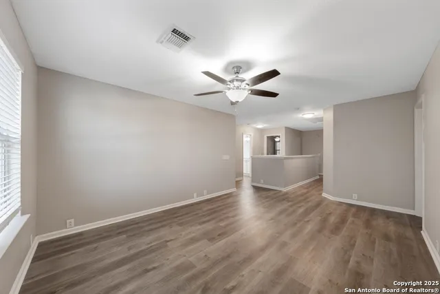 wooden floor in an empty room with a window