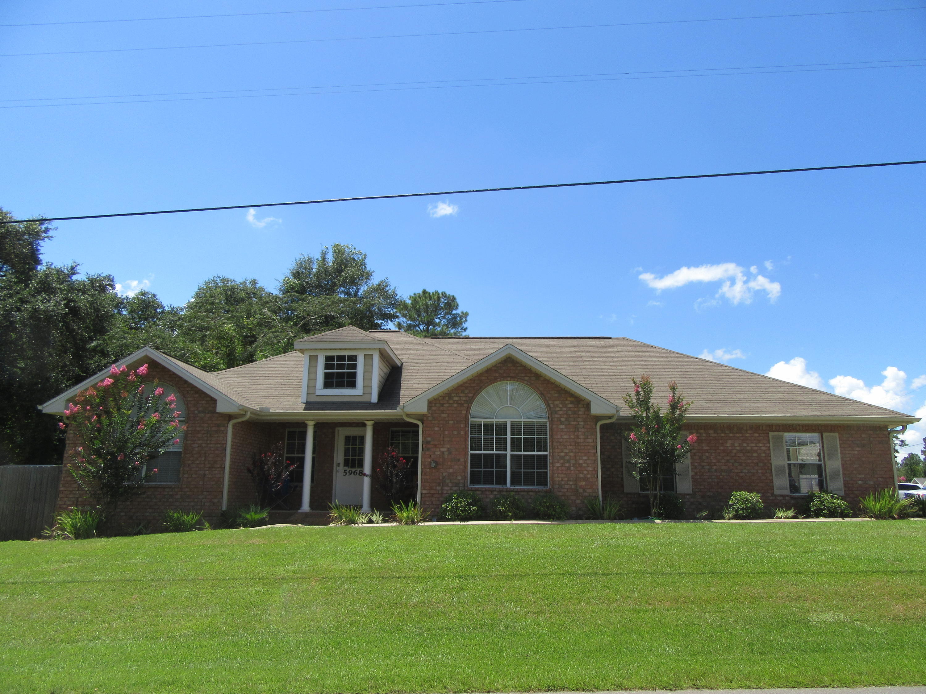 5968 Buckward Road Baker, FL 32531 - Photo 2 of 52 a front view of a house with a yard