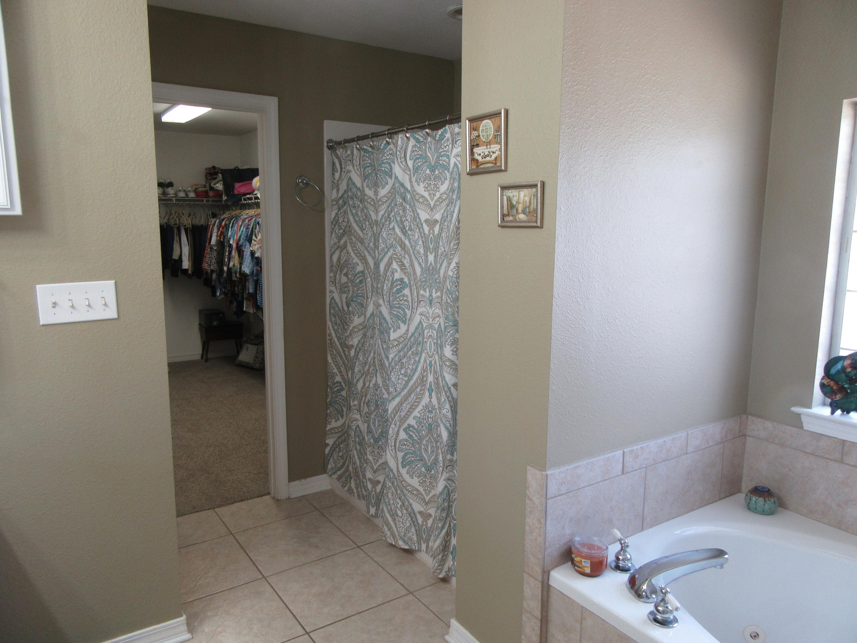 5968 Buckward Road Baker, FL 32531 - Photo 14 of 52 a bathroom with a bathtub and shower