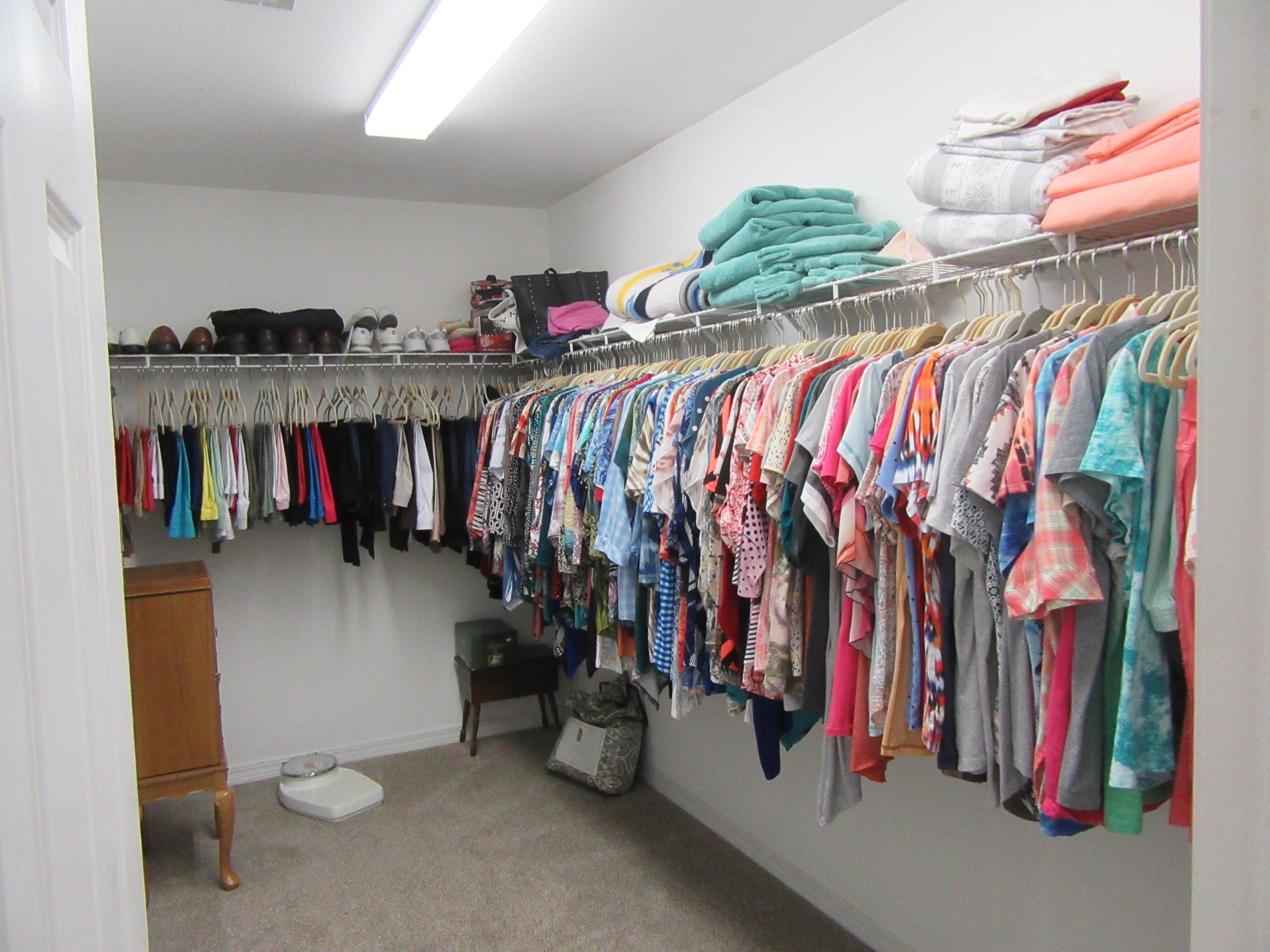5968 Buckward Road Baker, FL 32531 - Photo 15 of 52 a view of walk in closet with clothes and shoes
