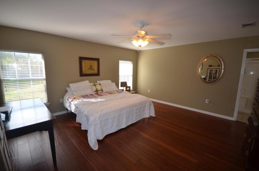 5968 Buckward Road Baker, FL 32531 - Photo 16 of 52 a spacious bedroom with a bed and a chandelier