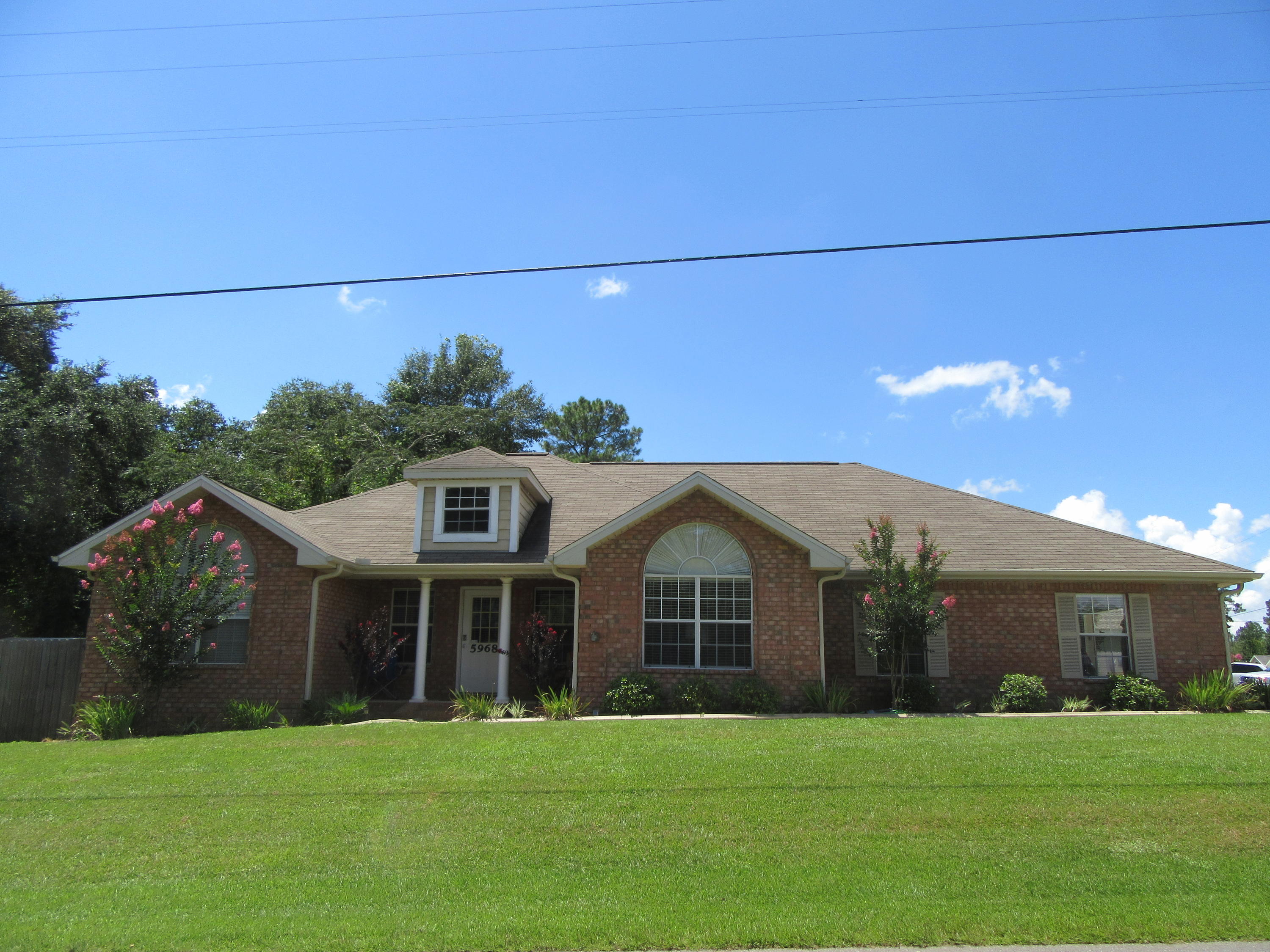 5968 Buckward Road Baker, FL 32531 - Photo 3 of 52 a front view of a house with a yard