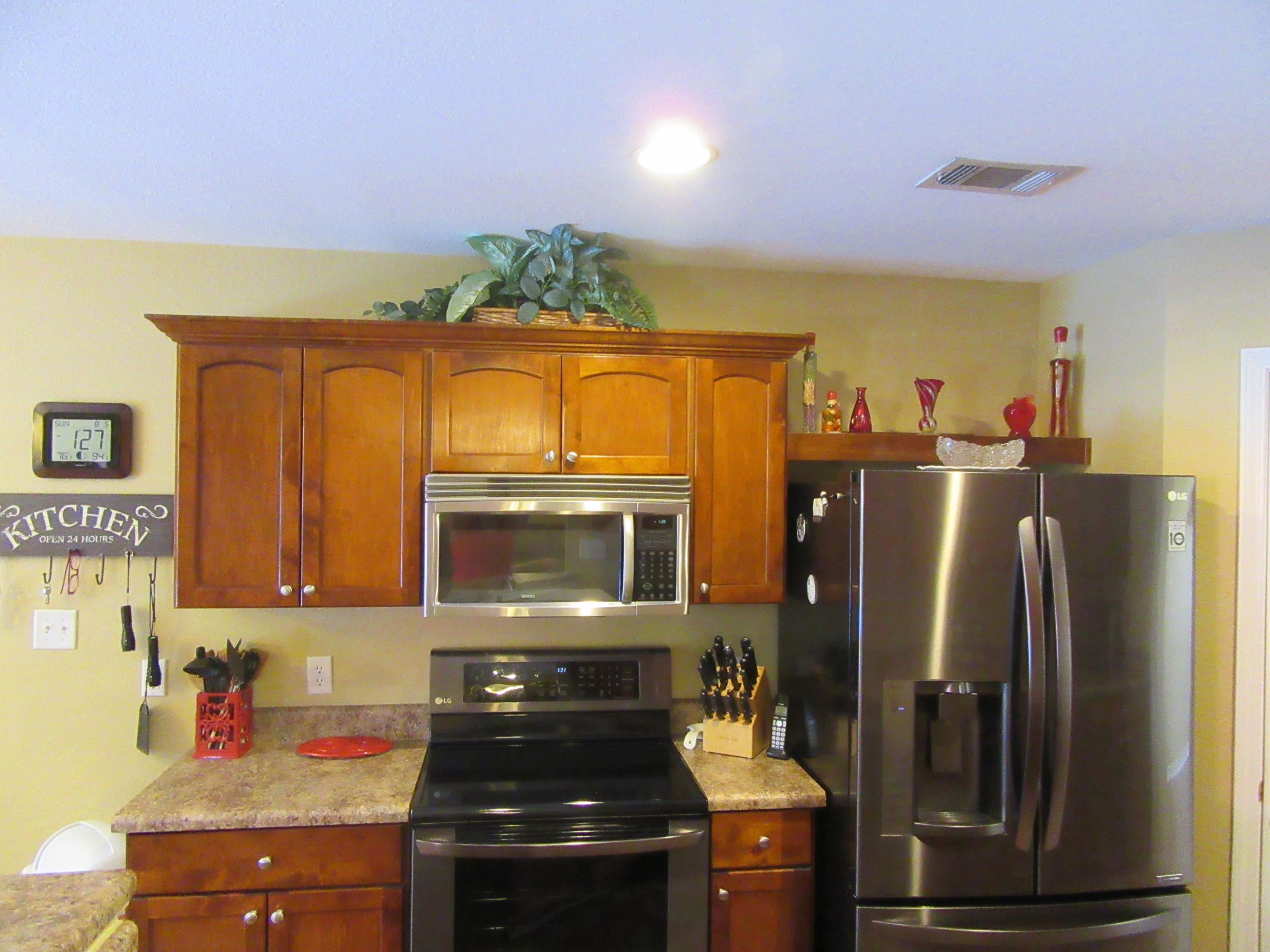 5968 Buckward Road Baker, FL 32531 - Photo 22 of 52 a kitchen with stainless steel appliances granite countertop a refrigerator a stove and a sink