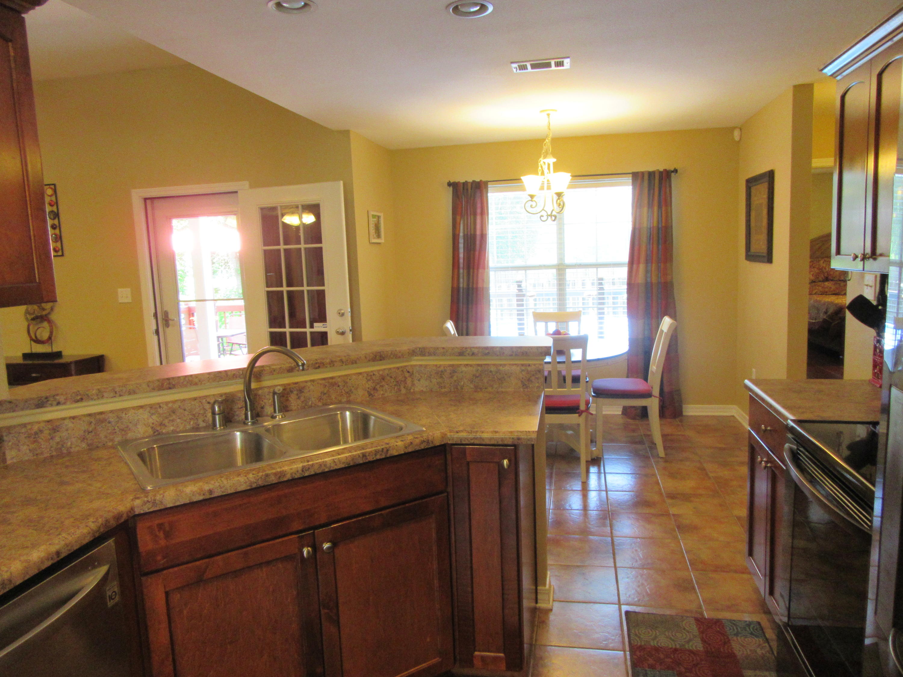 5968 Buckward Road Baker, FL 32531 - Photo 23 of 52 a kitchen with a sink and large windows