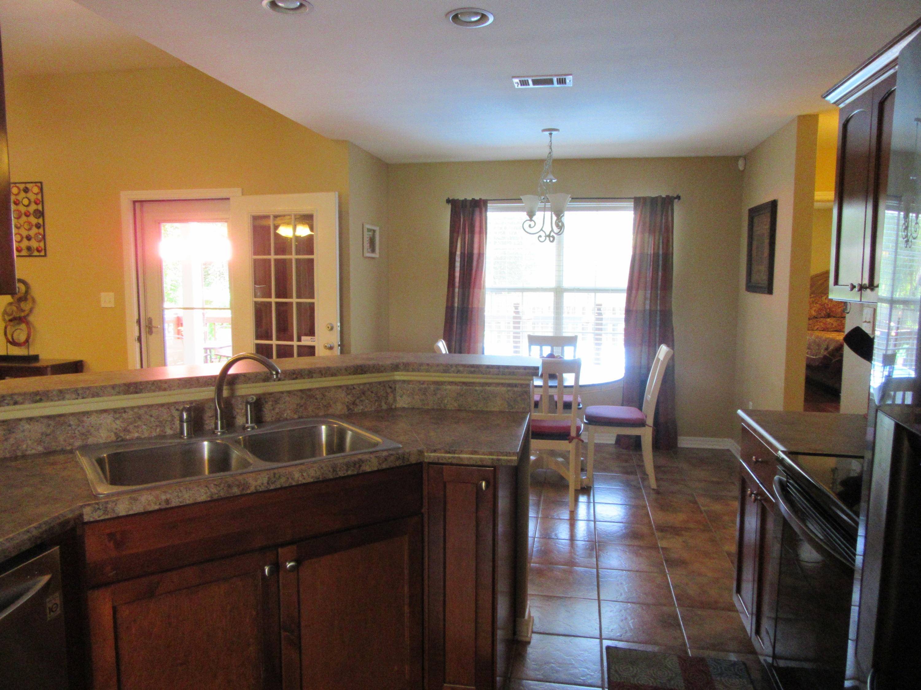 5968 Buckward Road Baker, FL 32531 - Photo 24 of 52 a dining hall with stainless steel appliances granite countertop a sink and dishwasher a stove next to a window