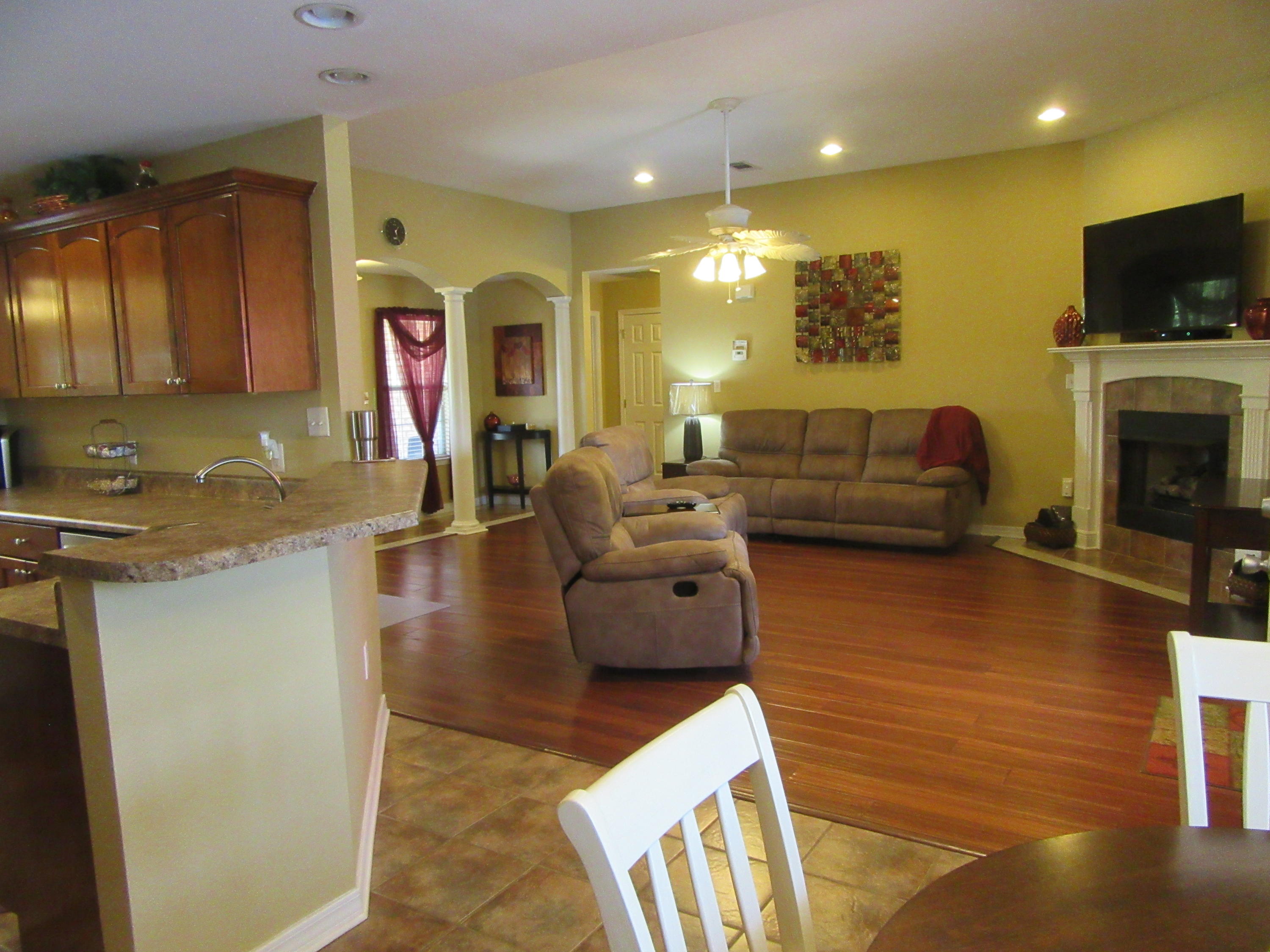 5968 Buckward Road Baker, FL 32531 - Photo 25 of 52 a living room with furniture and a flat screen tv