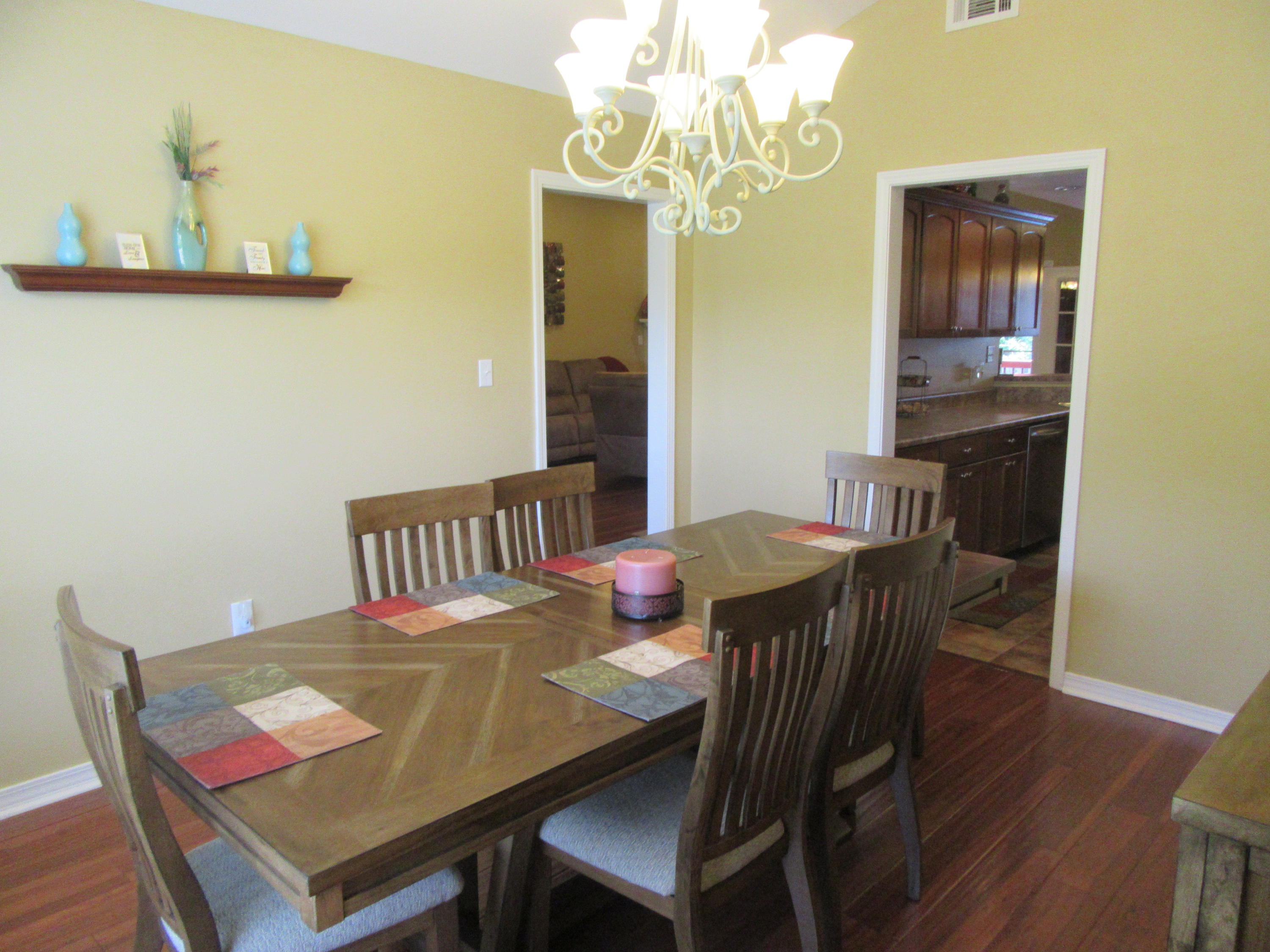 5968 Buckward Road Baker, FL 32531 - Photo 30 of 52 a view of a dining room with furniture and wooden floor
