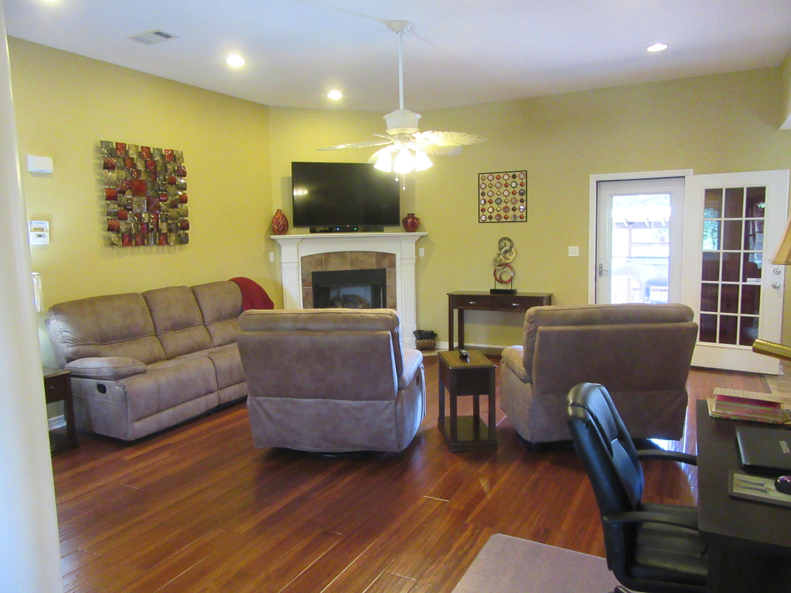 5968 Buckward Road Baker, FL 32531 - Photo 32 of 52 a living room with furniture a fireplace and a dining table with a bookshelf