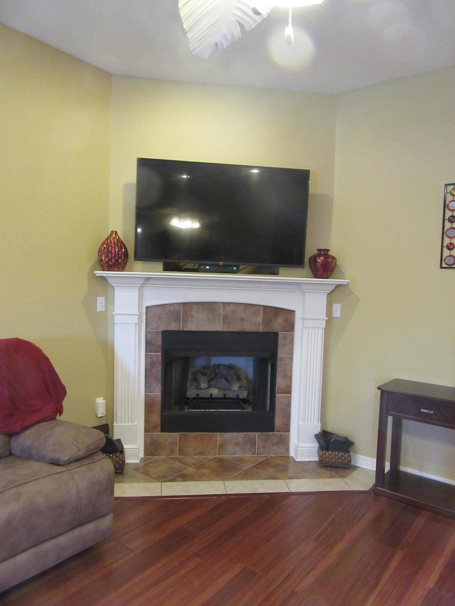 5968 Buckward Road Baker, FL 32531 - Photo 33 of 52 a living room with a fireplace and a flat screen tv