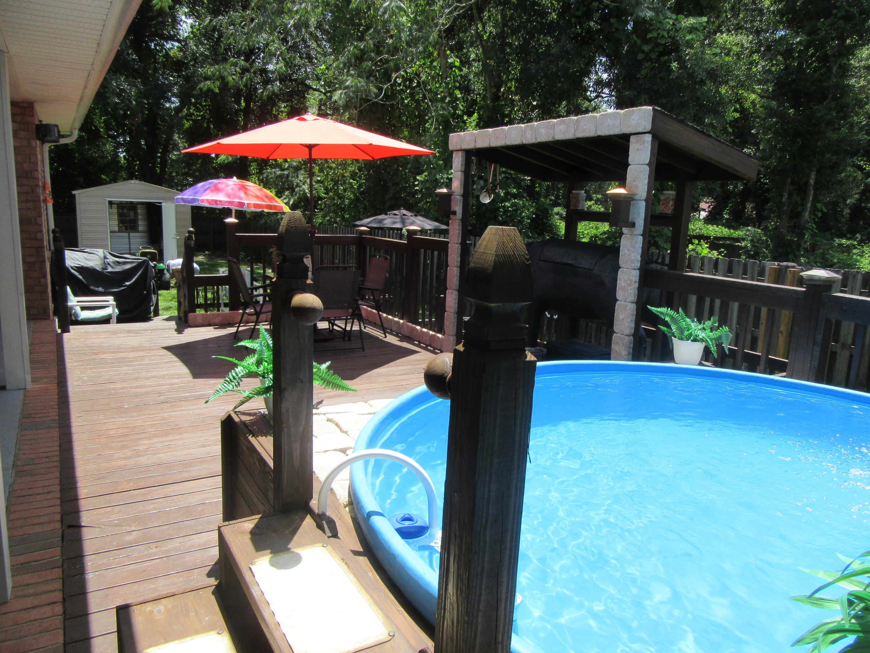 5968 Buckward Road Baker, FL 32531 - Photo 42 of 52 a view of a patio with a table and chairs under an umbrella
