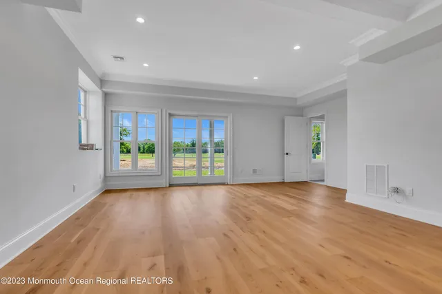 a view of a livingroom with wooden floor and stairs