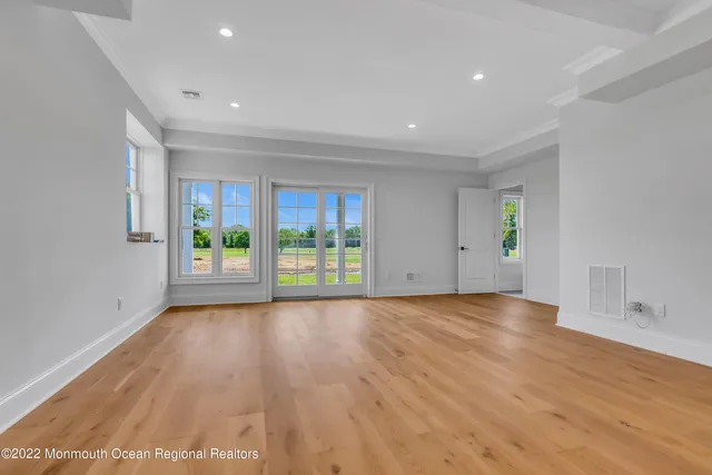 a living room with furniture and a view of kitchen