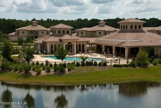an outdoor sitting area with furniture and garden
