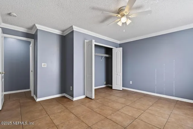 a view of an empty room with a ceiling fan