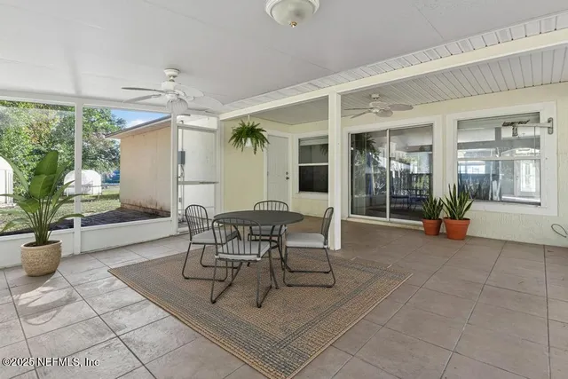 a view of a patio with a dining table and chairs
