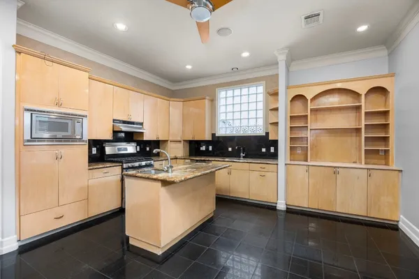 a kitchen with a sink window and cabinets