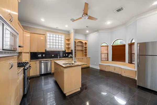 a kitchen with a stove a sink and a refrigerator