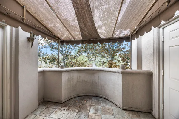 a view of an empty room with window and cabinet