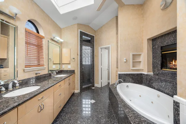 a spacious bathroom with a bathtub and a shower