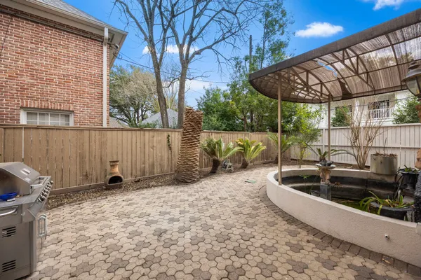 a view of a house with a small yard and sitting area