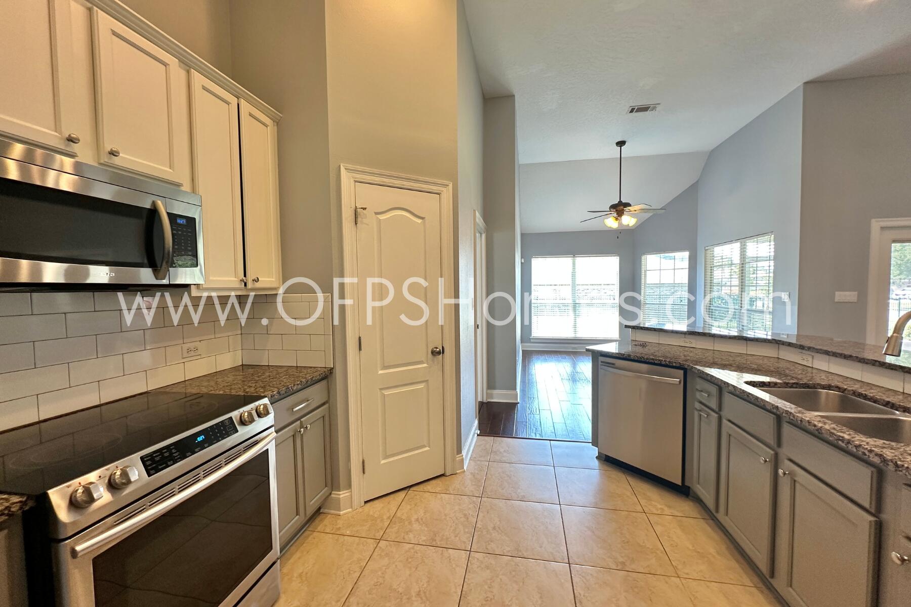 4611 Chanan Drive Crestview, FL 32539 - Photo 17 of 36 a kitchen with stainless steel appliances granite countertop a stove a sink and a microwave