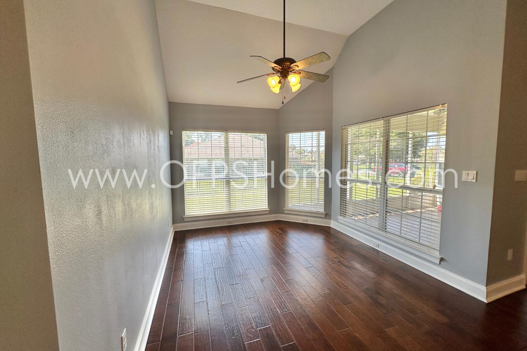 4611 Chanan Drive Crestview, FL 32539 - Photo 19 of 36 a view of an empty room with a window and wooden floor