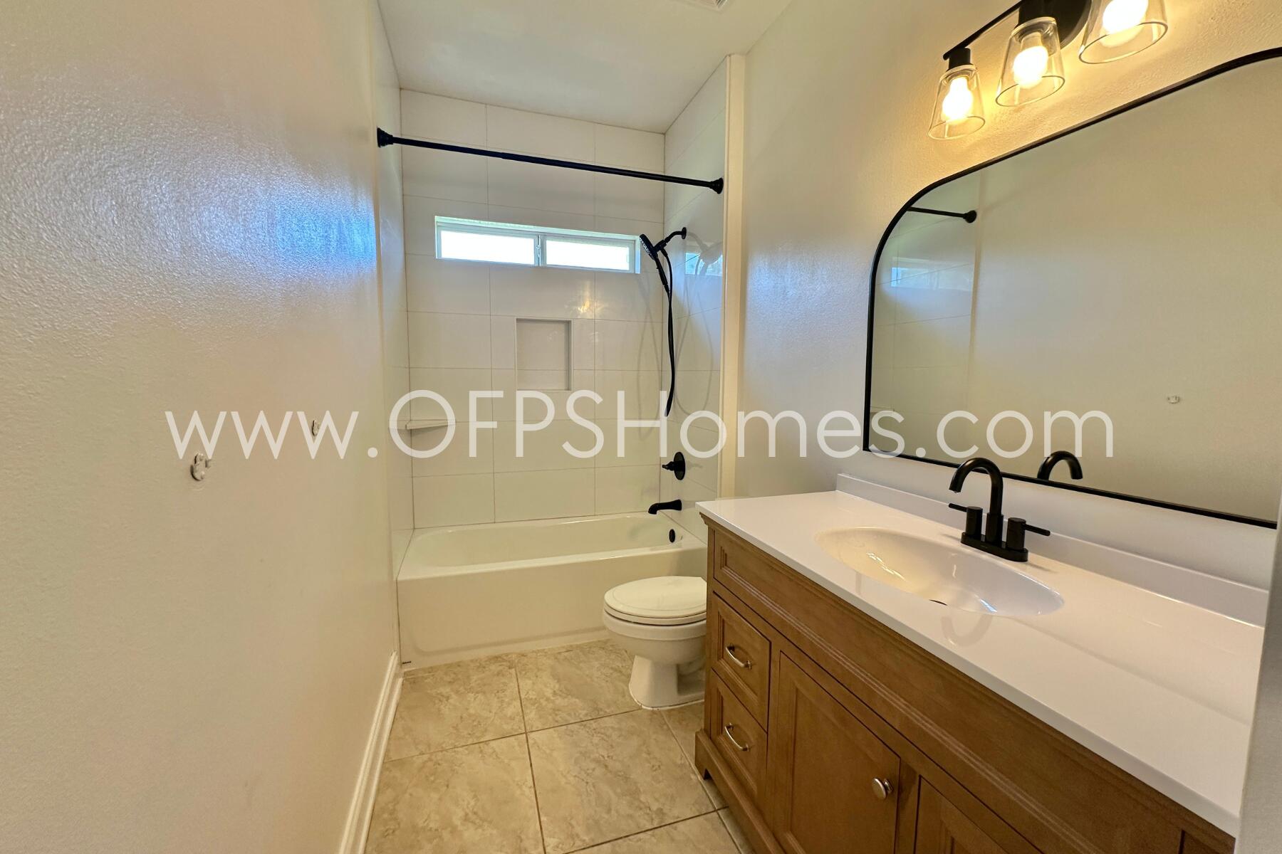 4611 Chanan Drive Crestview, FL 32539 - Photo 21 of 36 a bathroom with a double vanity sink toilet mirror and shower