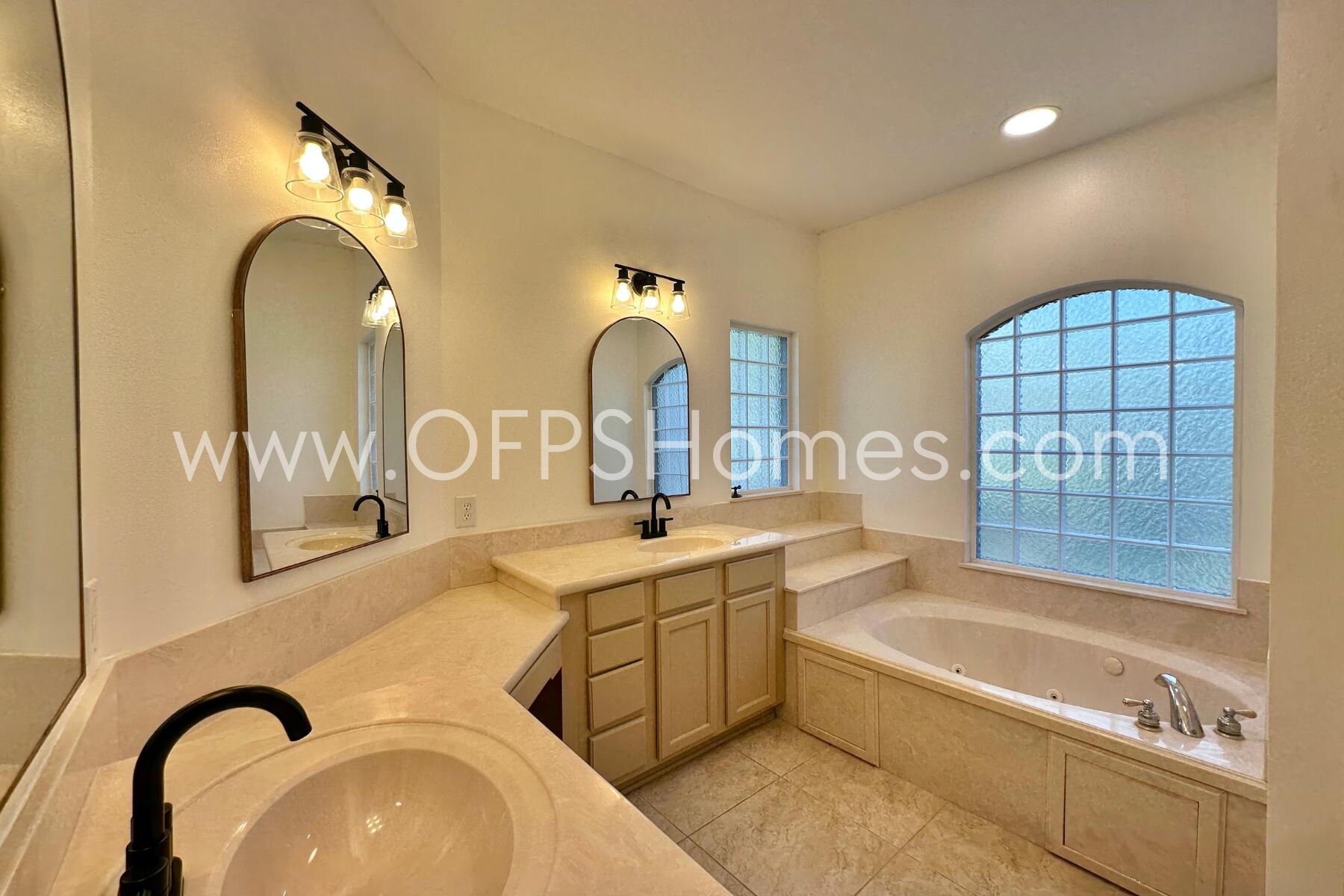4611 Chanan Drive Crestview, FL 32539 - Photo 25 of 36 a spacious bathroom with a sink a mirror a bathtub and window