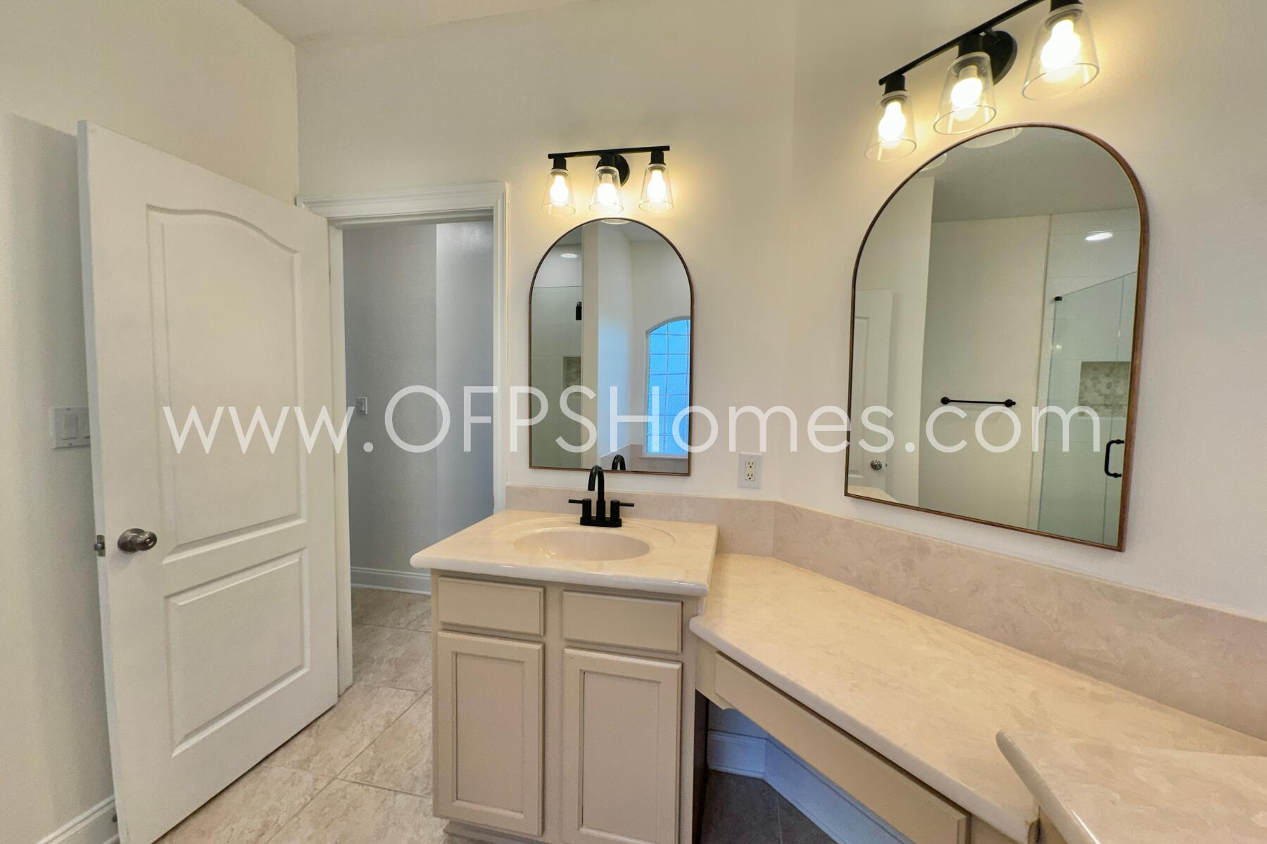 4611 Chanan Drive Crestview, FL 32539 - Photo 26 of 36 a bathroom with a double vanity sink and a mirror