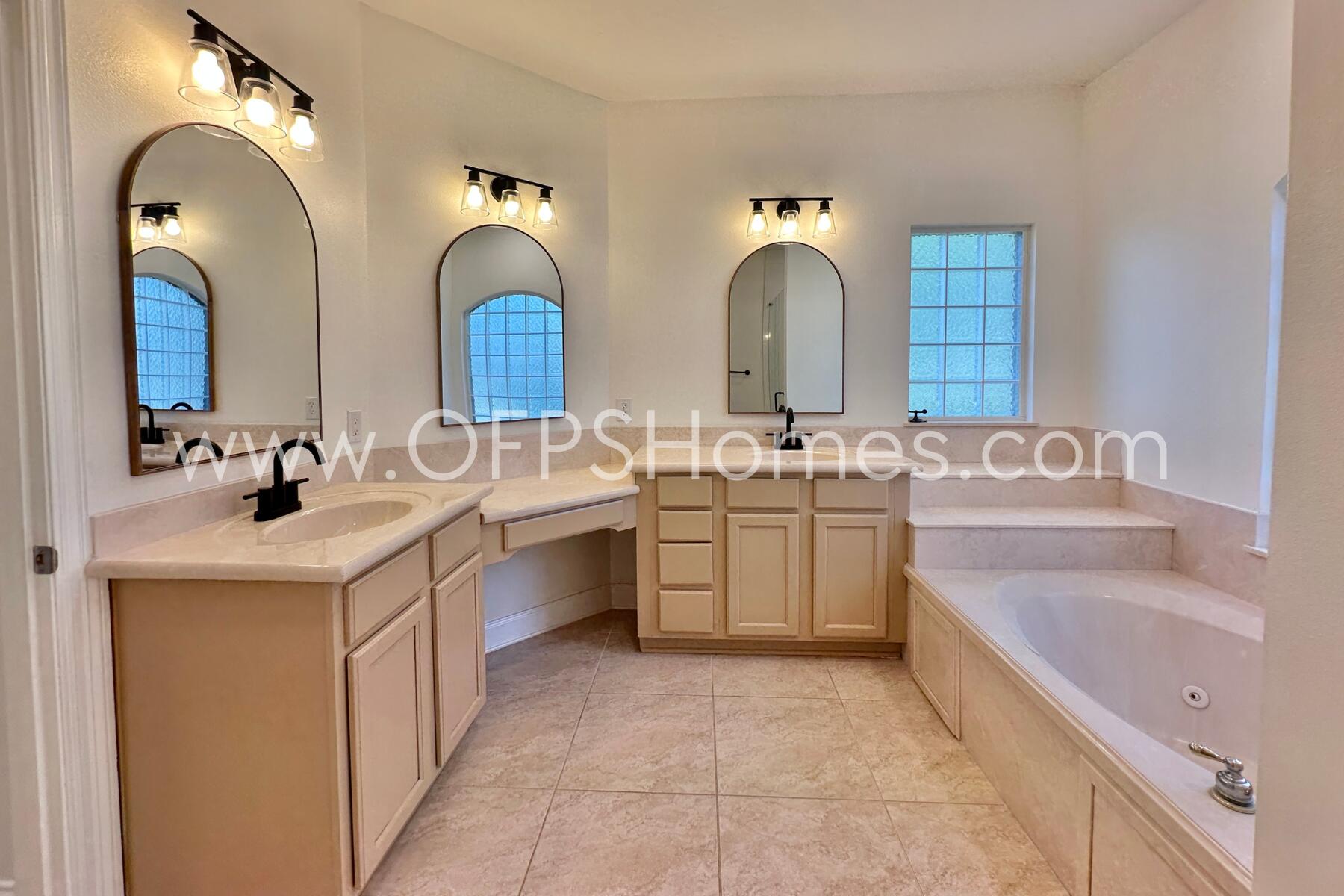 4611 Chanan Drive Crestview, FL 32539 - Photo 28 of 36 a bathroom with a double vanity sink and a bathtub