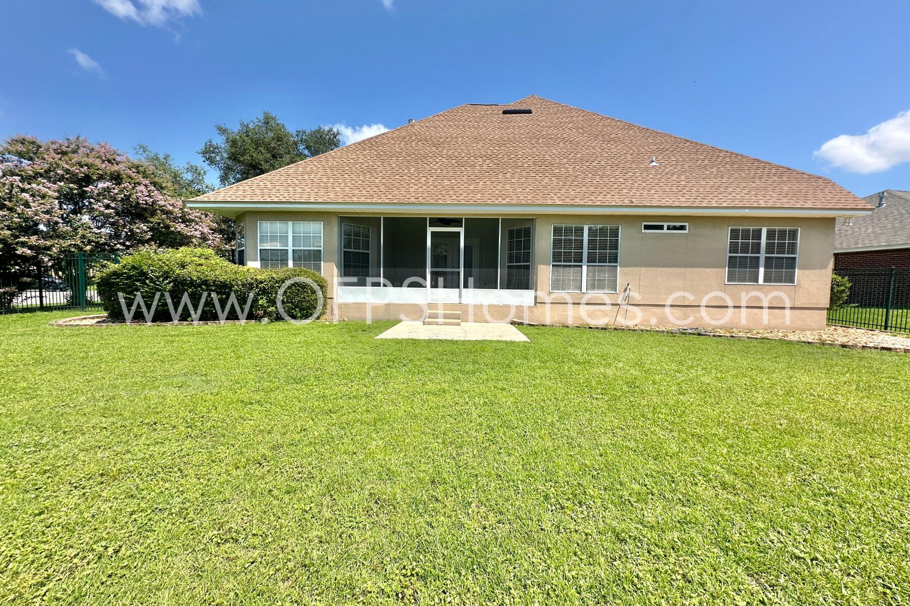 4611 Chanan Drive Crestview, FL 32539 - Photo 35 of 36 a front view of a house with a yard table and chairs
