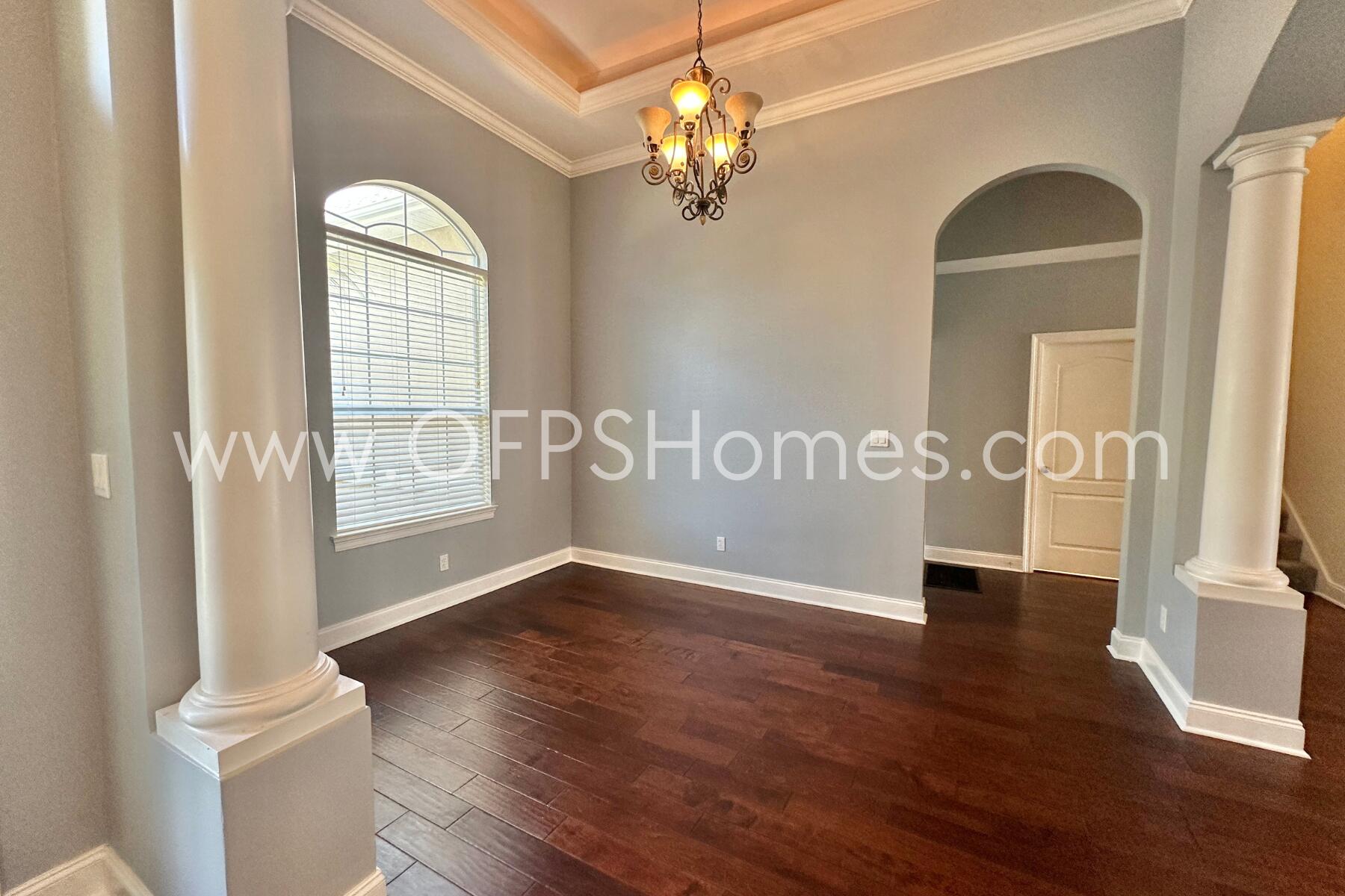 4611 Chanan Drive Crestview, FL 32539 - Photo 8 of 36 a view of an empty room with wooden floor and a window