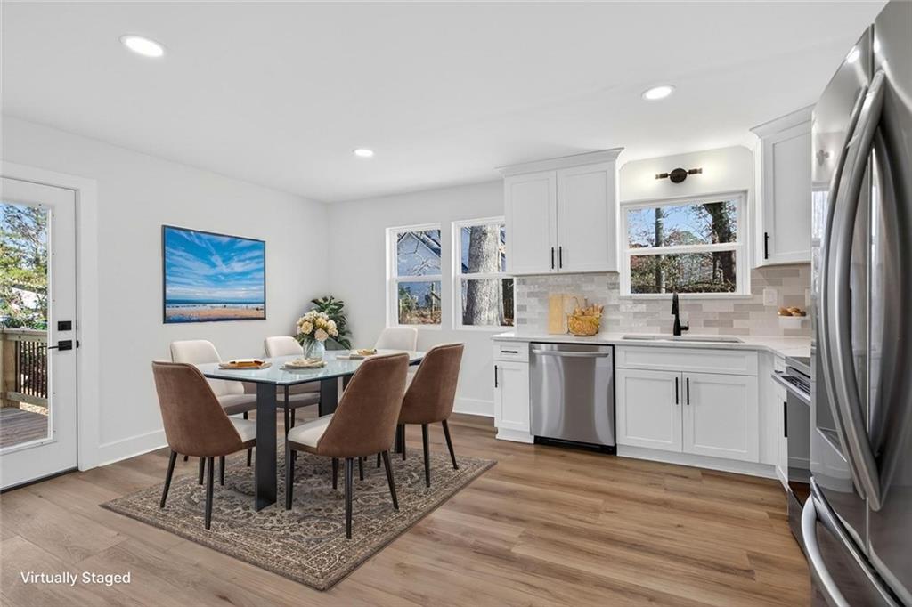 4190 Heather Way Cumming, GA 30041 - Photo 13 of 45 a open dining room with stainless steel appliances granite countertop a sink a stove a dining table and chairs