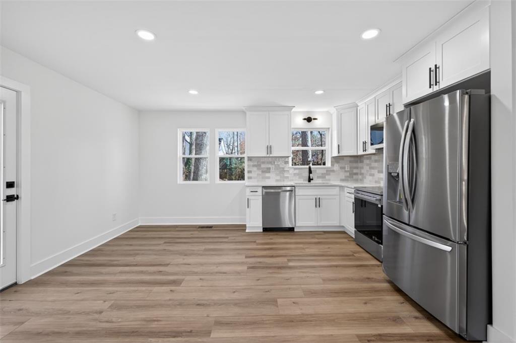 4190 Heather Way Cumming, GA 30041 - Photo 15 of 45 a kitchen with stainless steel appliances a refrigerator sink and cabinets