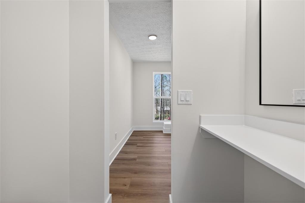 4190 Heather Way Cumming, GA 30041 - Photo 20 of 45 a view of a hallway with wooden floor and entryway