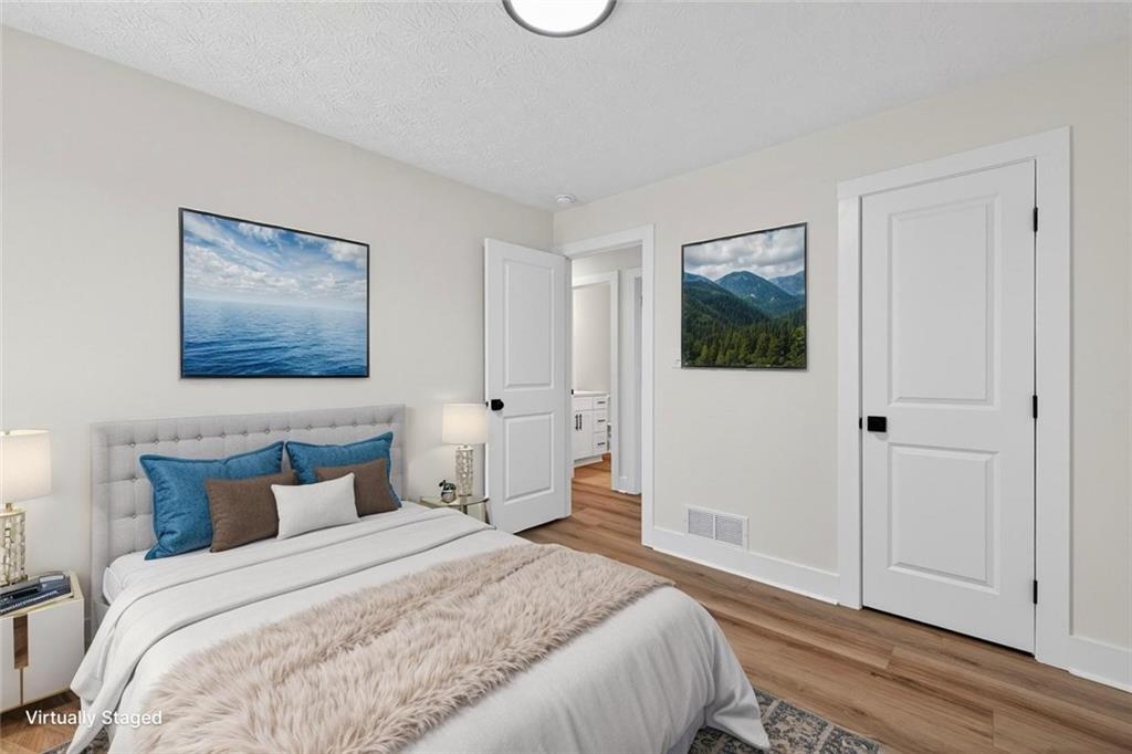 4190 Heather Way Cumming, GA 30041 - Photo 22 of 45 a bedroom with a bed and a painting on the wall