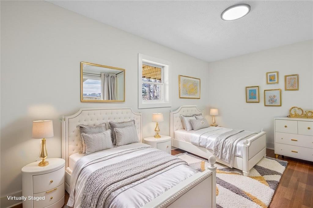 4190 Heather Way Cumming, GA 30041 - Photo 28 of 45 a bedroom with two beds and a lamp on a dresser