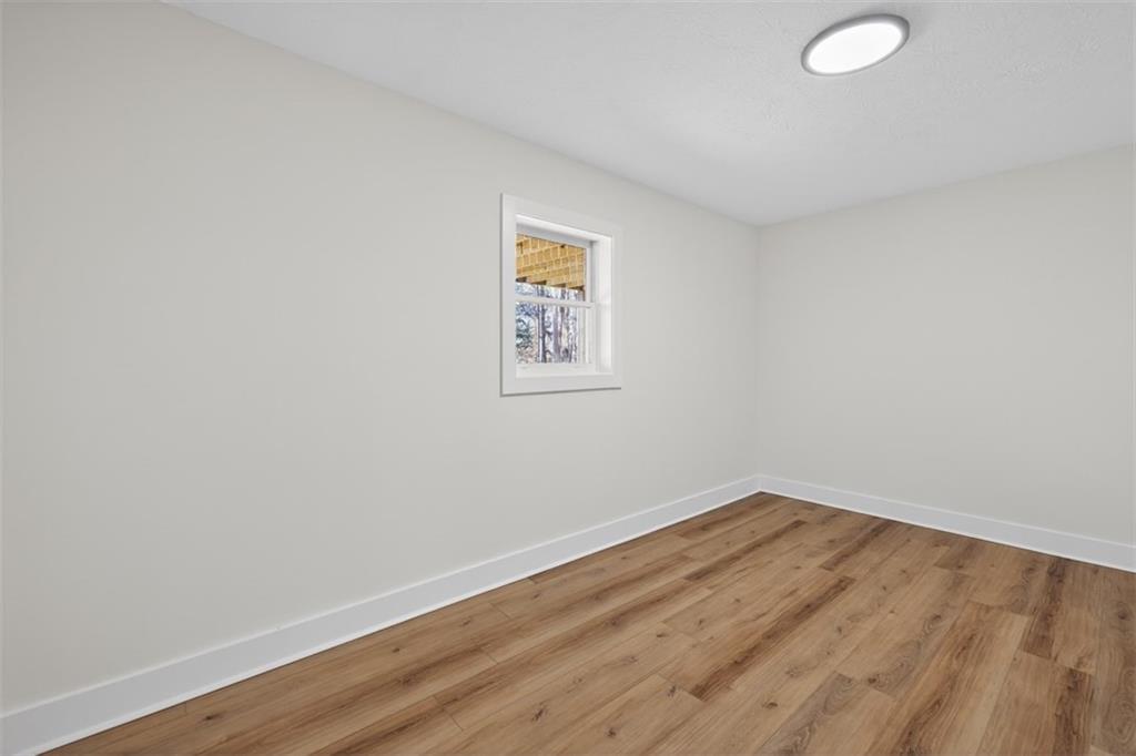 4190 Heather Way Cumming, GA 30041 - Photo 29 of 45 an empty room with wooden floor and windows
