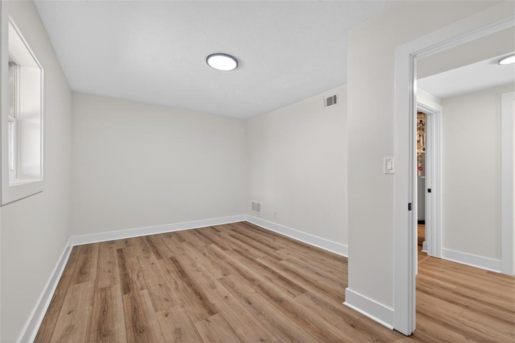 4190 Heather Way Cumming, GA 30041 - Photo 30 of 45 an empty room with wooden floor and windows